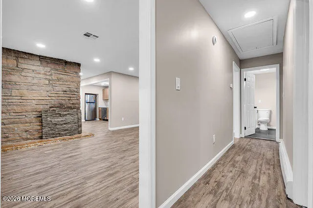 a view of a hallway with wooden floor