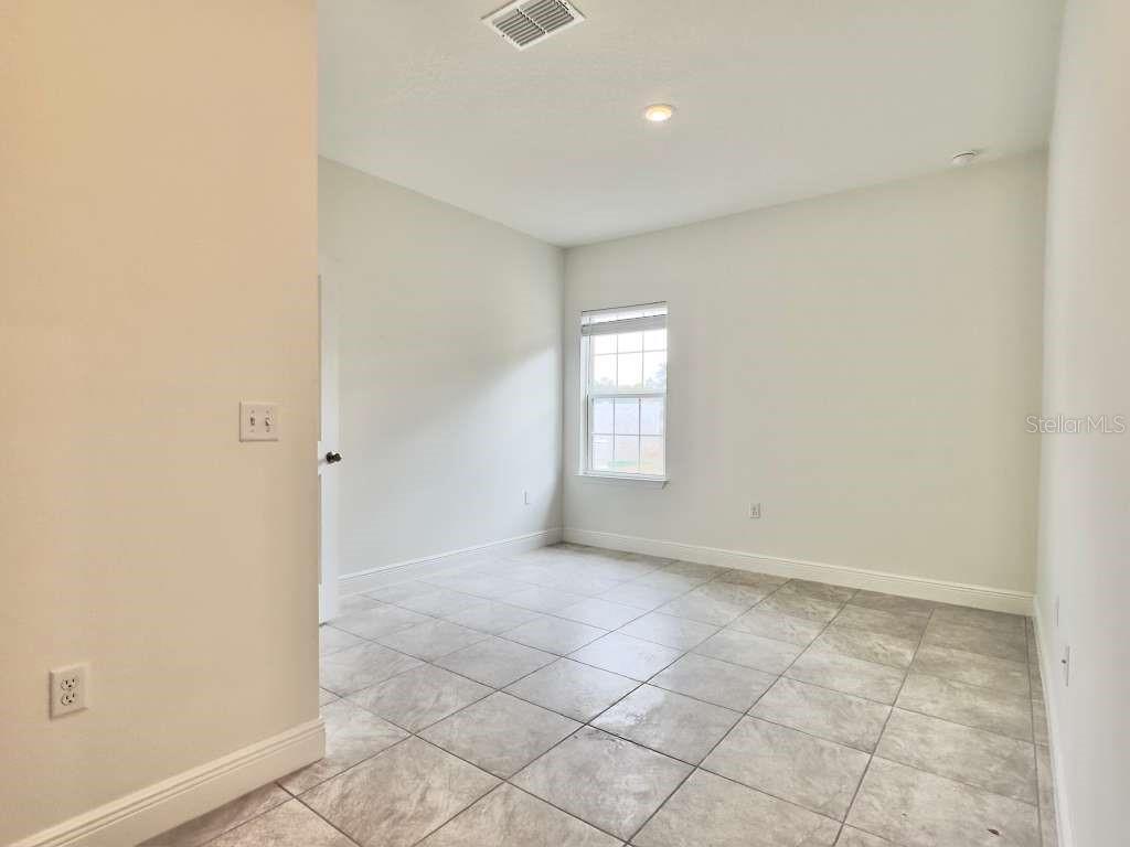 15885 Southwest 35th Court Road, Unit 1 Ocala, FL 34473 - Photo 6 of 27 an empty room with windows