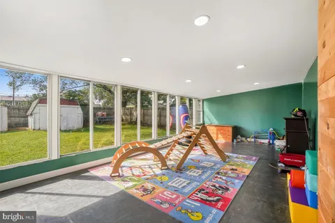 a bed room with furniture and a floor to ceiling window