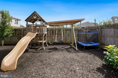 a view of a wooden roof deck with a backyard