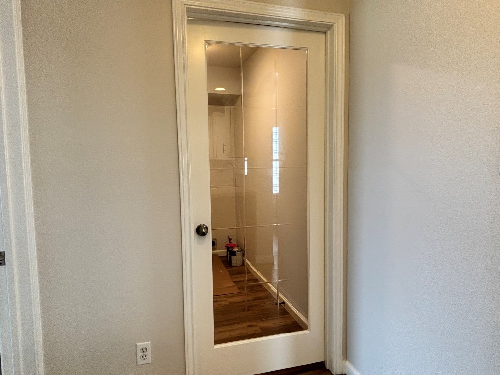 1702 McDowell Bend Leander, TX 78641 - Photo 11 of 13 a view of a hallway with a wooden door