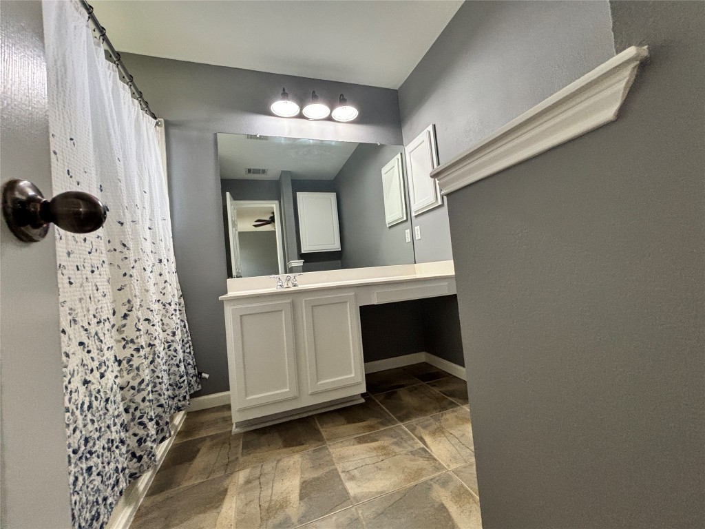 1702 McDowell Bend Leander, TX 78641 - Photo 6 of 13 a view of bathroom with a sink and a mirror