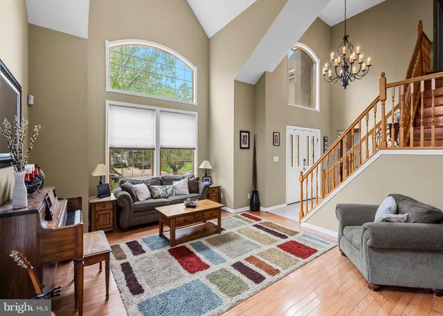 a living room with furniture and a chandelier