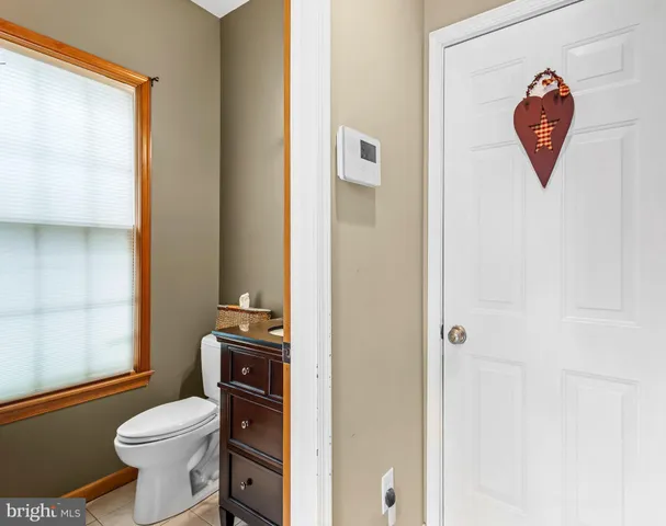 a white toilet sitting next to a bathroom sink
