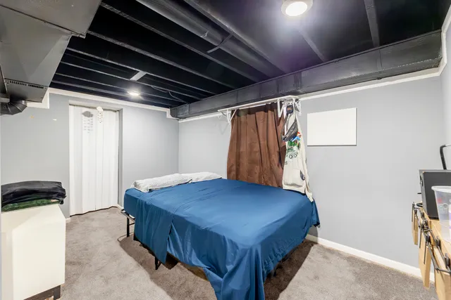 a bedroom with a bed and a dresser