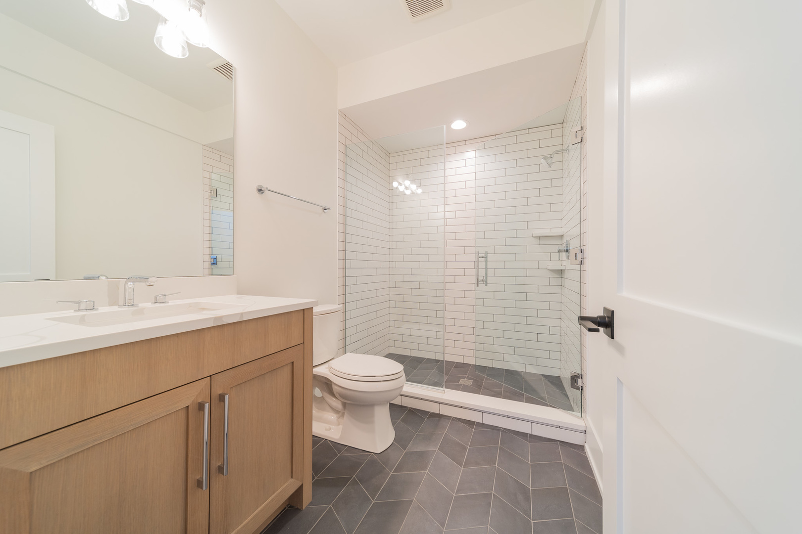2421 Sumac Circle Glenview, IL 60025 - Photo 26 of 27 a bathroom with a sink a toilet a shower and a mirror