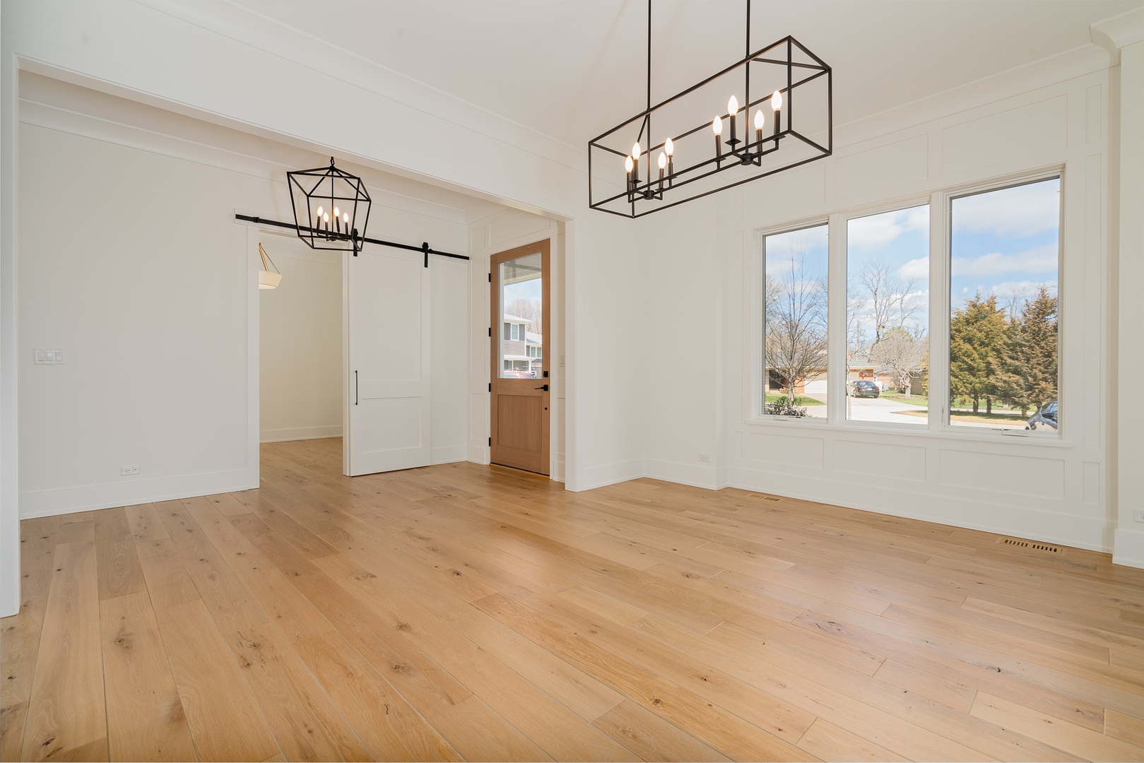 2421 Sumac Circle Glenview, IL 60025 - Photo 8 of 27 a view of big room with wooden floor windows and chandelier