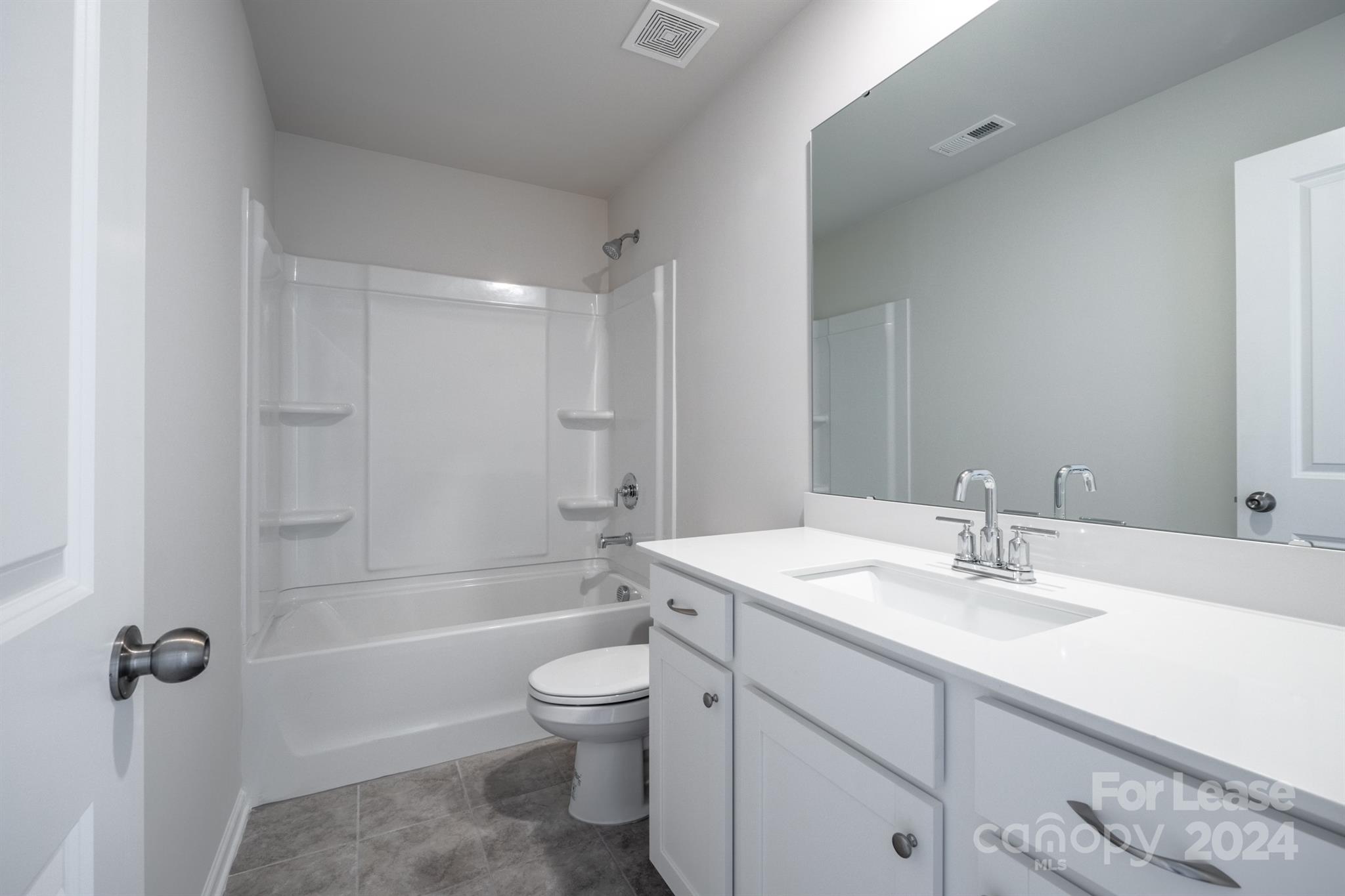 15307 Lake Ridge Road Charlotte, NC 28278 - Photo 19 of 33 a bathroom with a sink toilet and shower