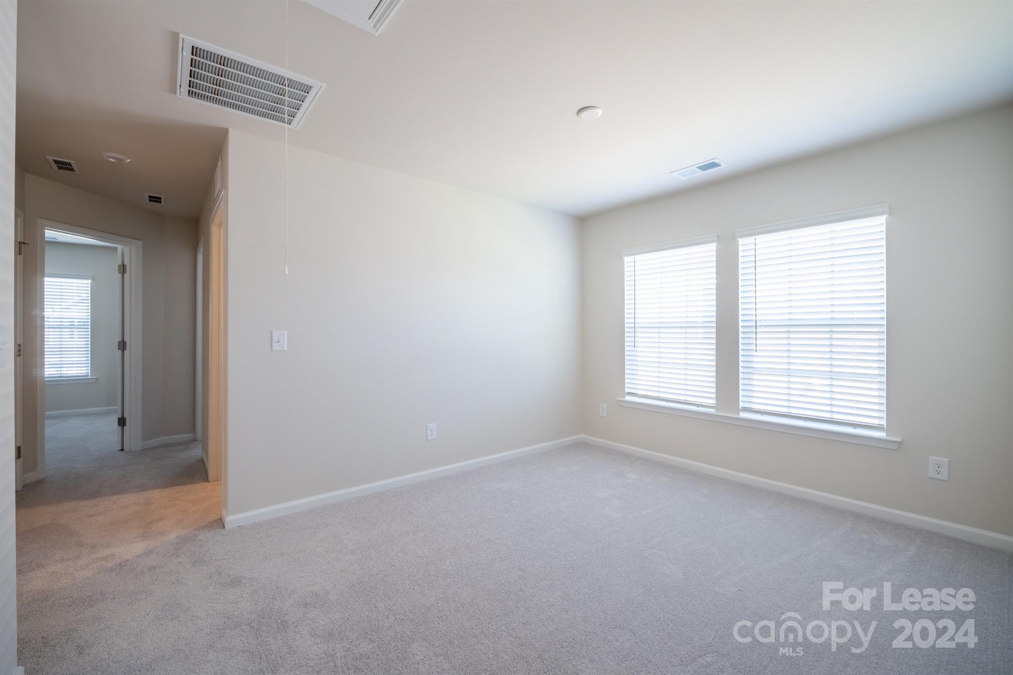 15307 Lake Ridge Road Charlotte, NC 28278 - Photo 20 of 33 an empty room with windows and closet