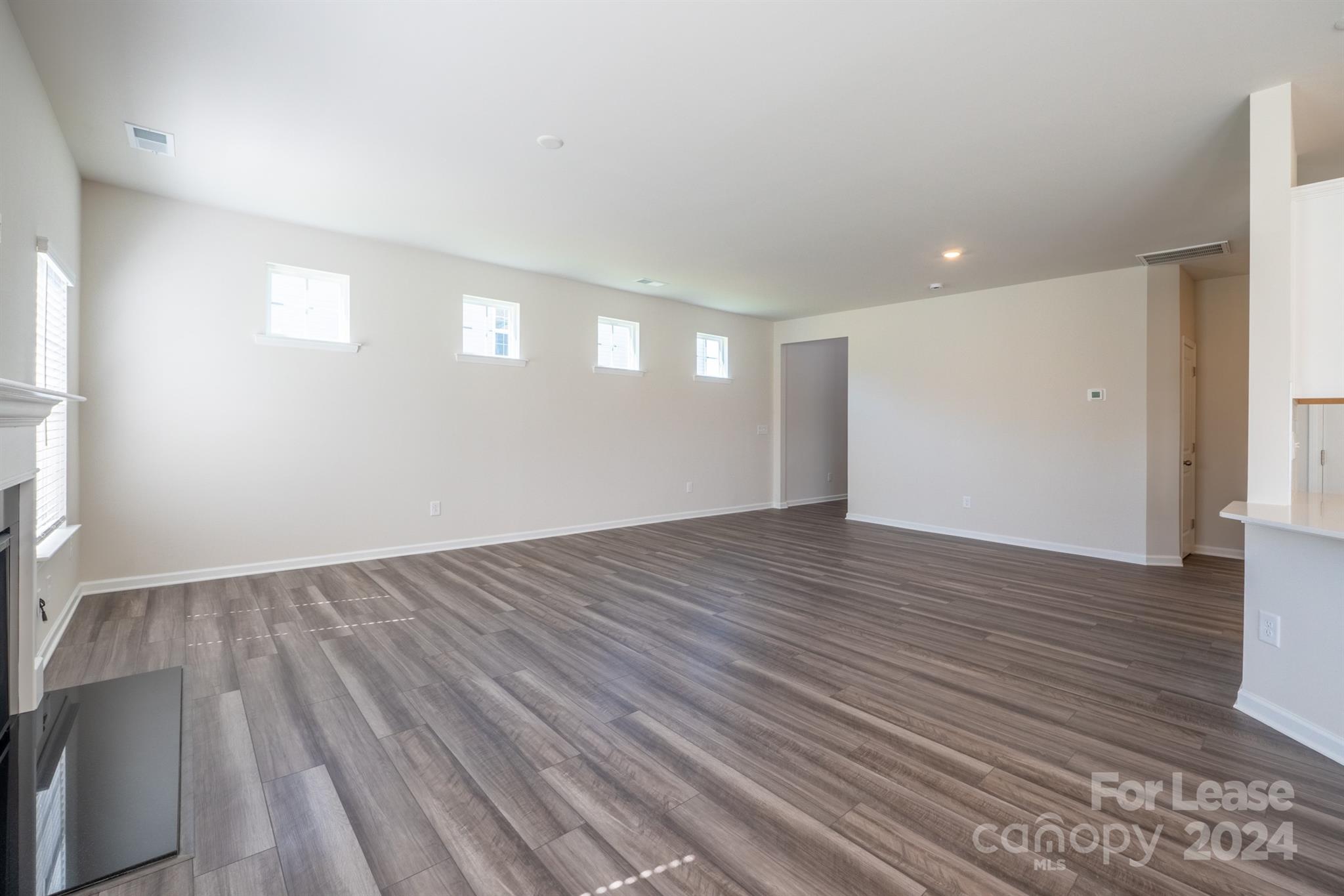 15307 Lake Ridge Road Charlotte, NC 28278 - Photo 7 of 33 a view of an empty room with wooden floor and a window