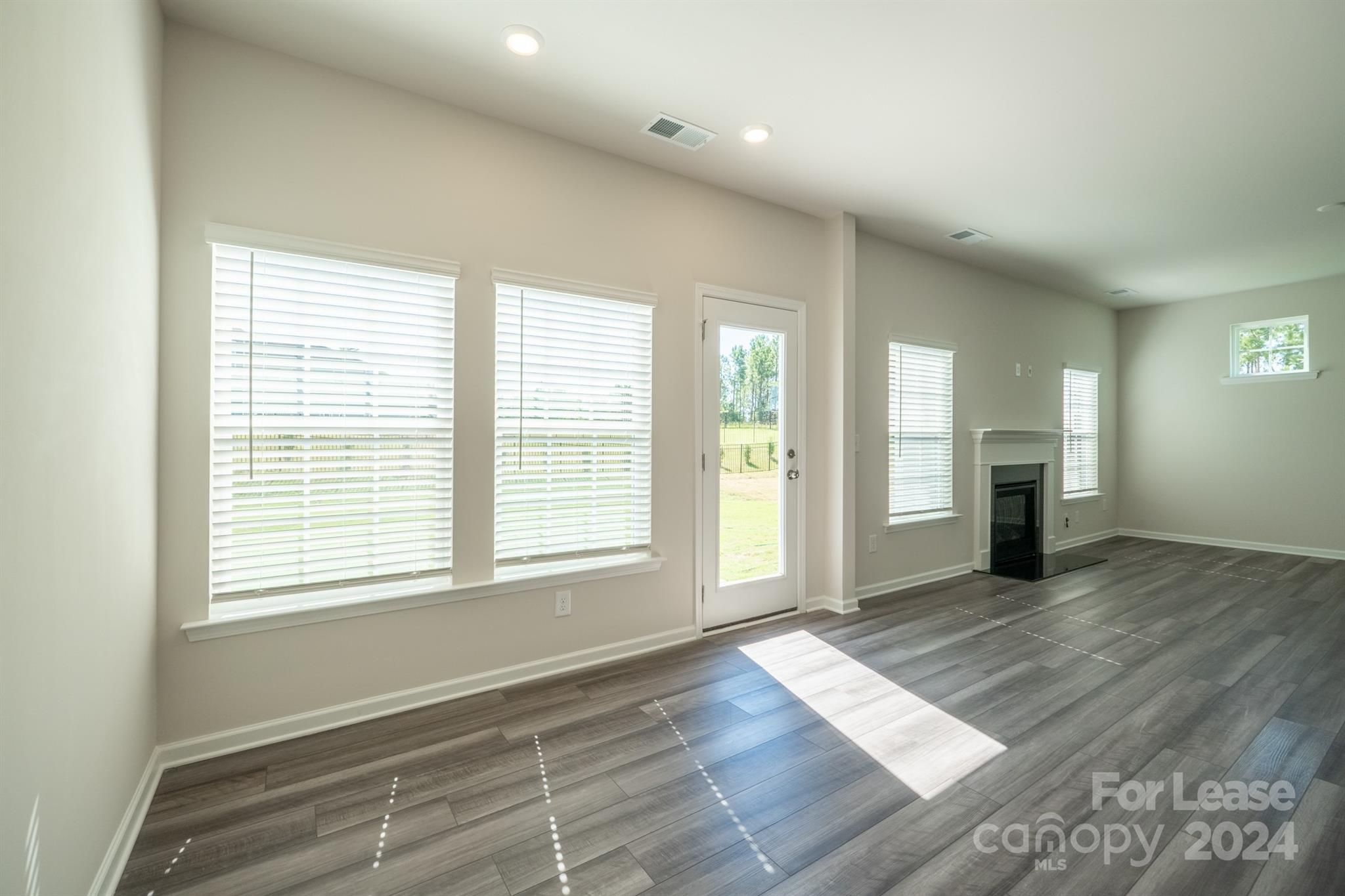 15307 Lake Ridge Road Charlotte, NC 28278 - Photo 8 of 33 a view of an empty room with wooden floor and a window