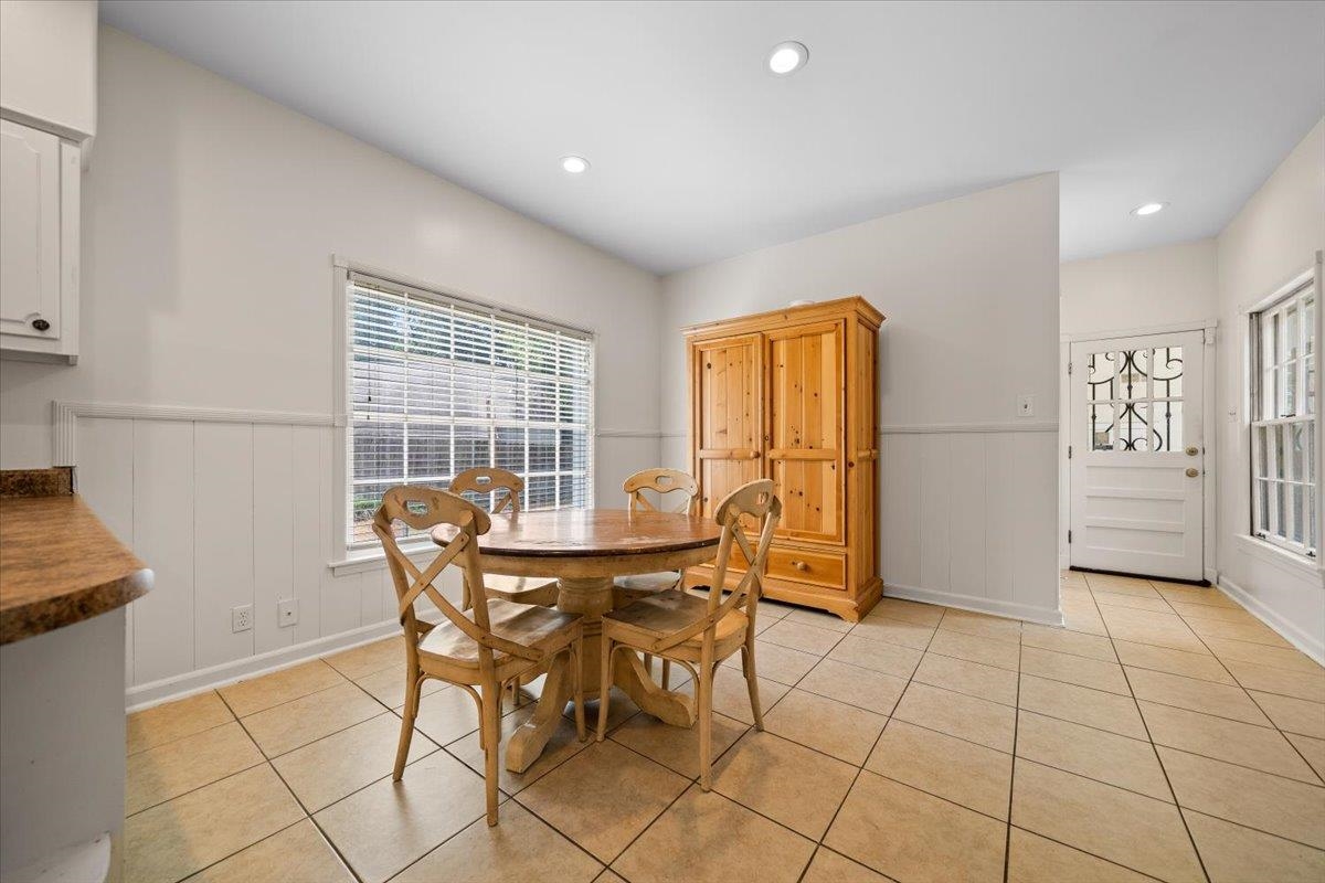 1273 Brookfield Road Memphis, TN 38119 - Photo 17 of 40 Spacious dining area featuring neutral tile flooring, recessed lighting, a large window with blinds, and wainscoting