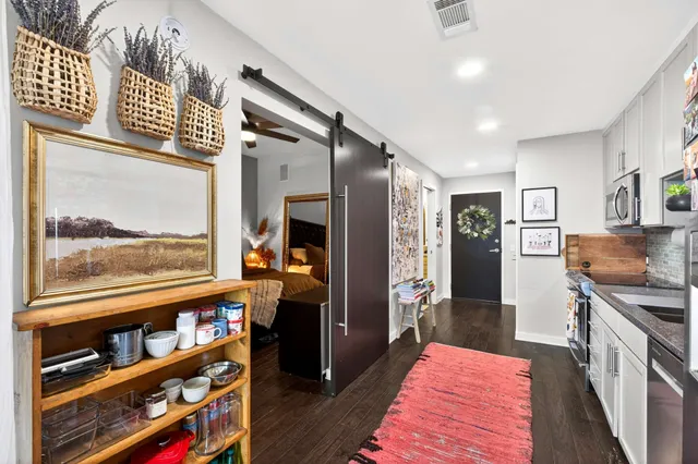 a hallway with wooden floor and furniture