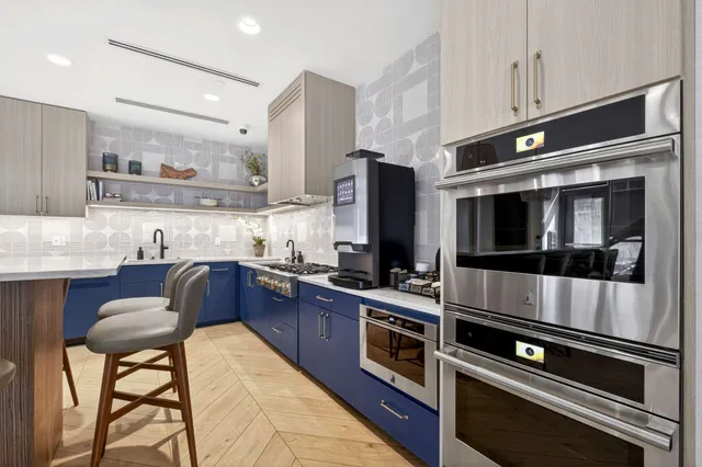 a large kitchen with a table and chairs