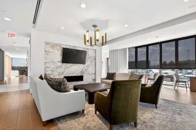 a workspace with furniture and floor to ceiling window