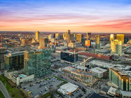 a living room with fireplace furniture and a large window