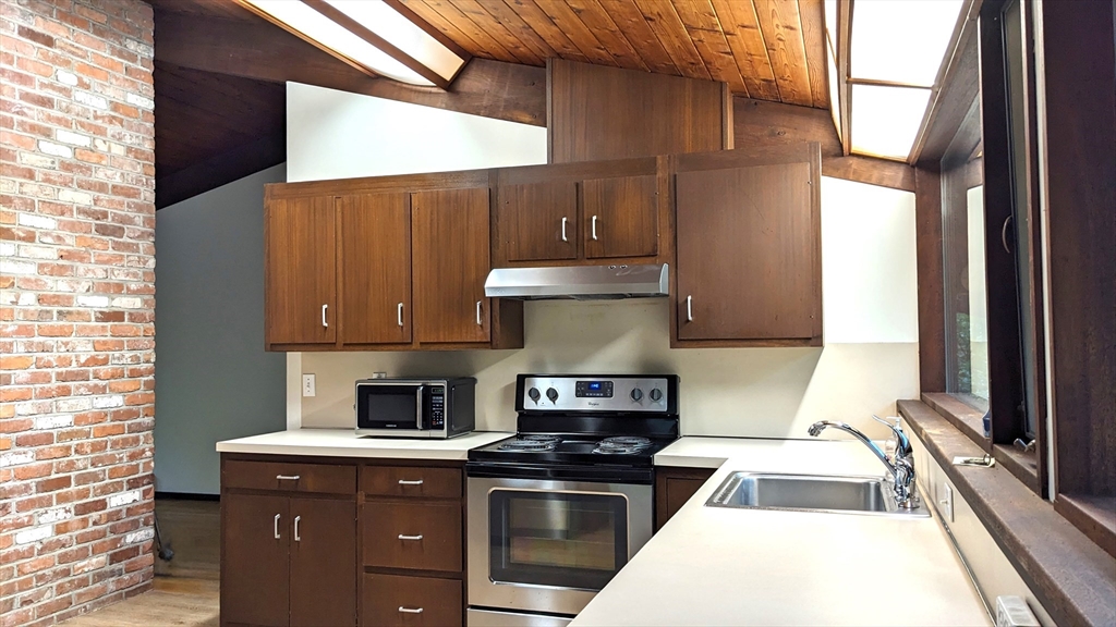 41 Belvedere Road Boxford, MA 01921 - Photo 2 of 16 a kitchen with a stove a sink and a microwave
