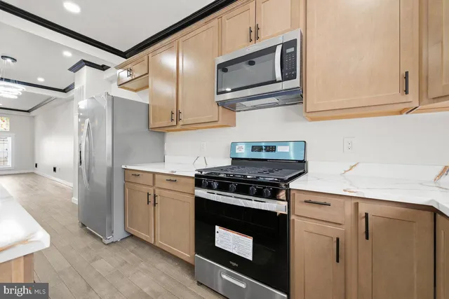 a kitchen with stainless steel appliances granite countertop a stove and a refrigerator
