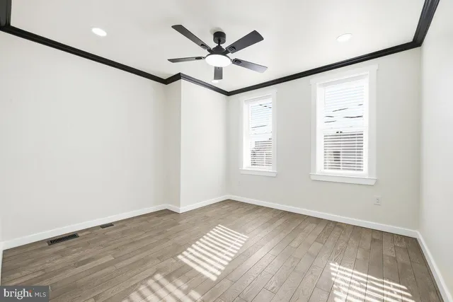 a view of workspace with wooden floor and ceiling fan