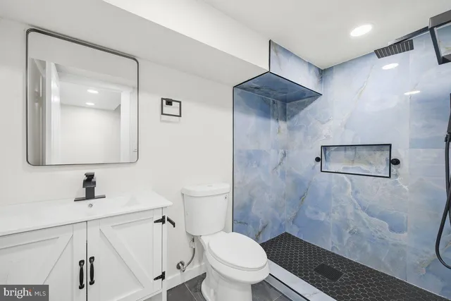 a bathroom with a toilet sink and a mirror