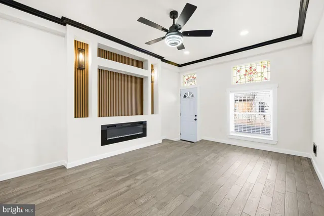 wooden floor in an empty room with a window