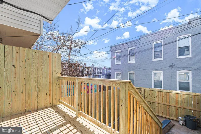 a view of a balcony with wooden floor