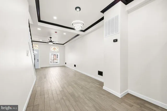 a view of a hallway with wooden floor