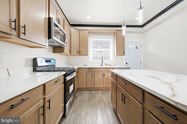 a kitchen with a sink stove and cabinets