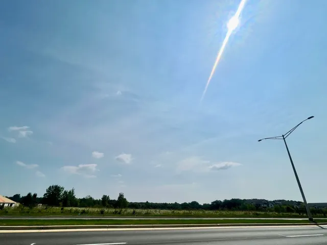 an aerial view of field with trees