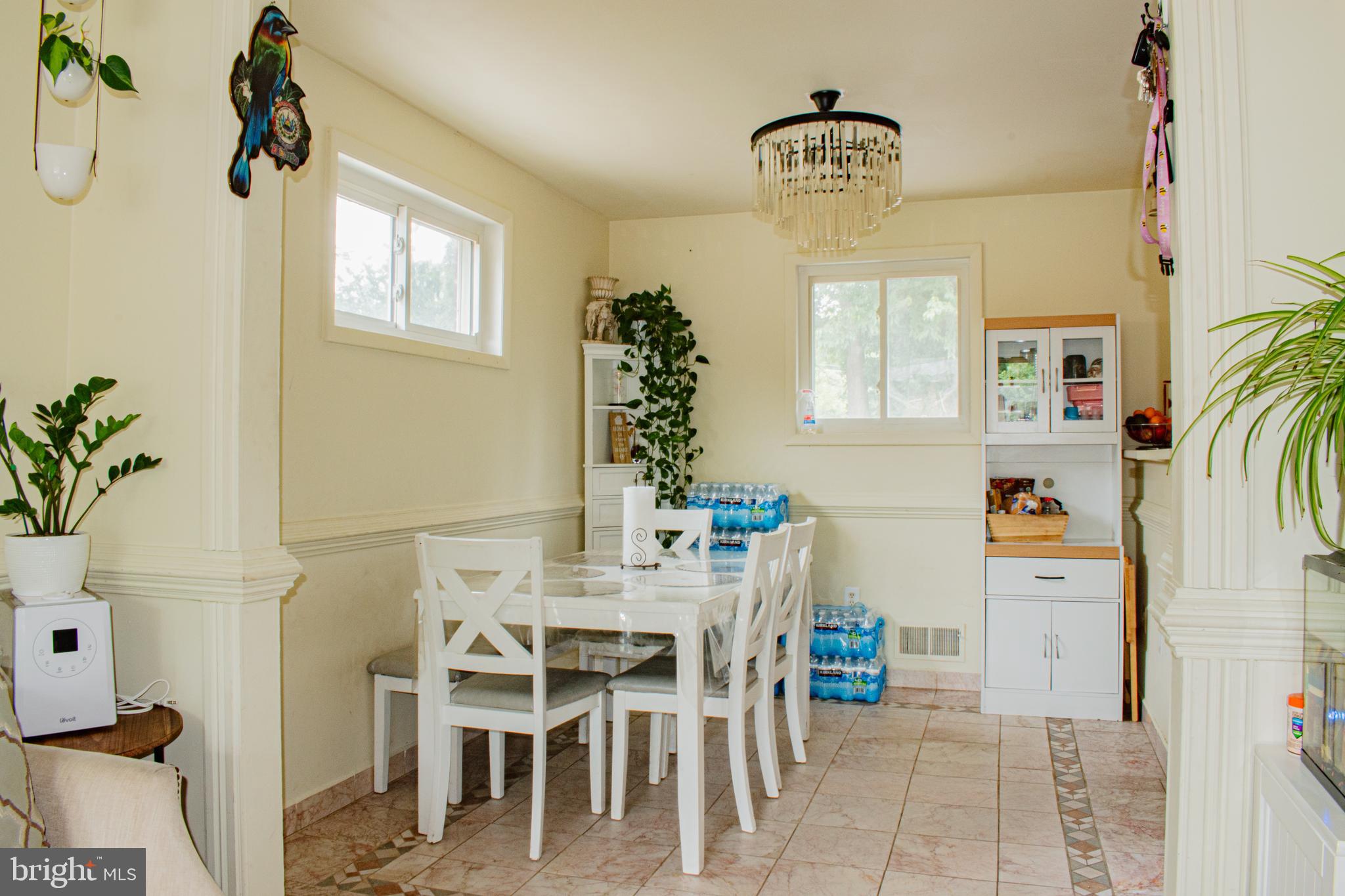 227 Hannes Street Silver Spring, MD 20901 - Photo 6 of 33 a dining room with furniture a chandelier and window