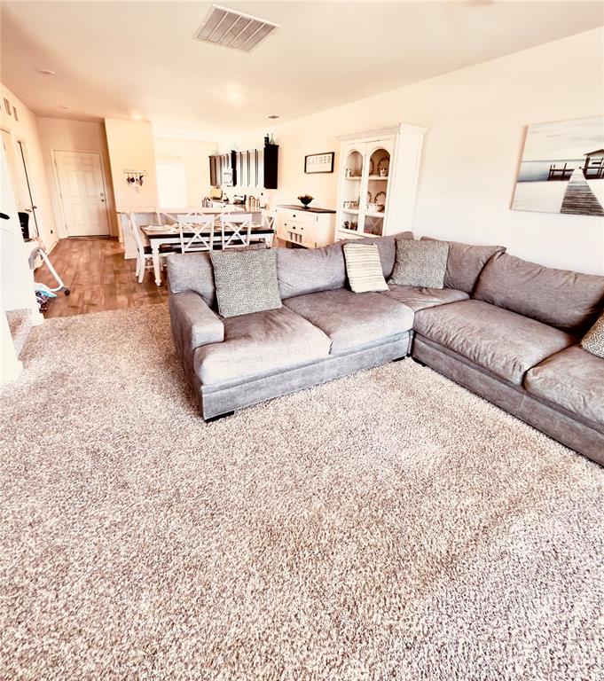 196 Cattlemans Crk Road West Newark, TX 76071 - Photo 5 of 24 Open-concept living area featuring light-colored walls and a neutral-toned carpet
