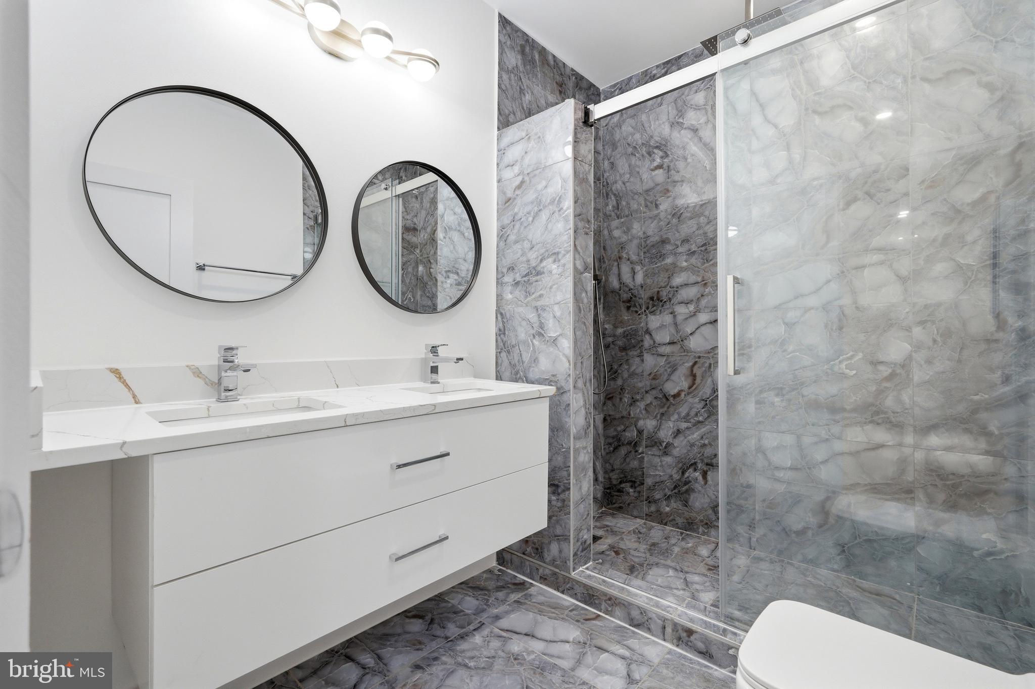 1810 Central Place Northeast, Unit 1 Washington, DC 20002 - Photo 31 of 36 a bathroom with a sink mirror and a shower
