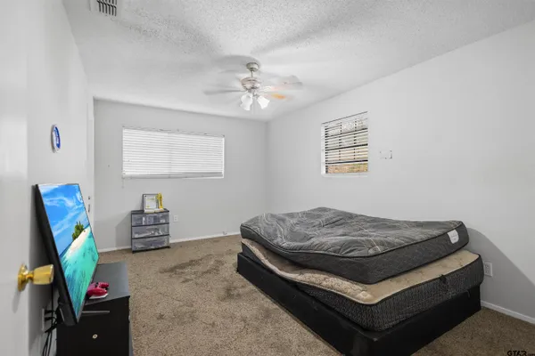 a bedroom with a bed and a chandelier