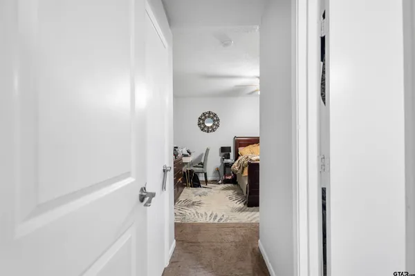 a bathroom with a granite countertop toilet sink and mirror