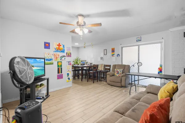 a living room with furniture and a chandelier