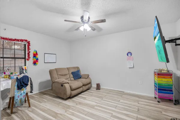 a living room with furniture and a wooden floor