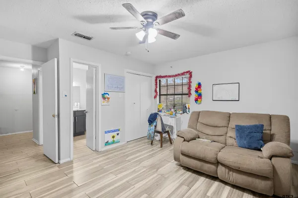 a living room with furniture and a wooden floor