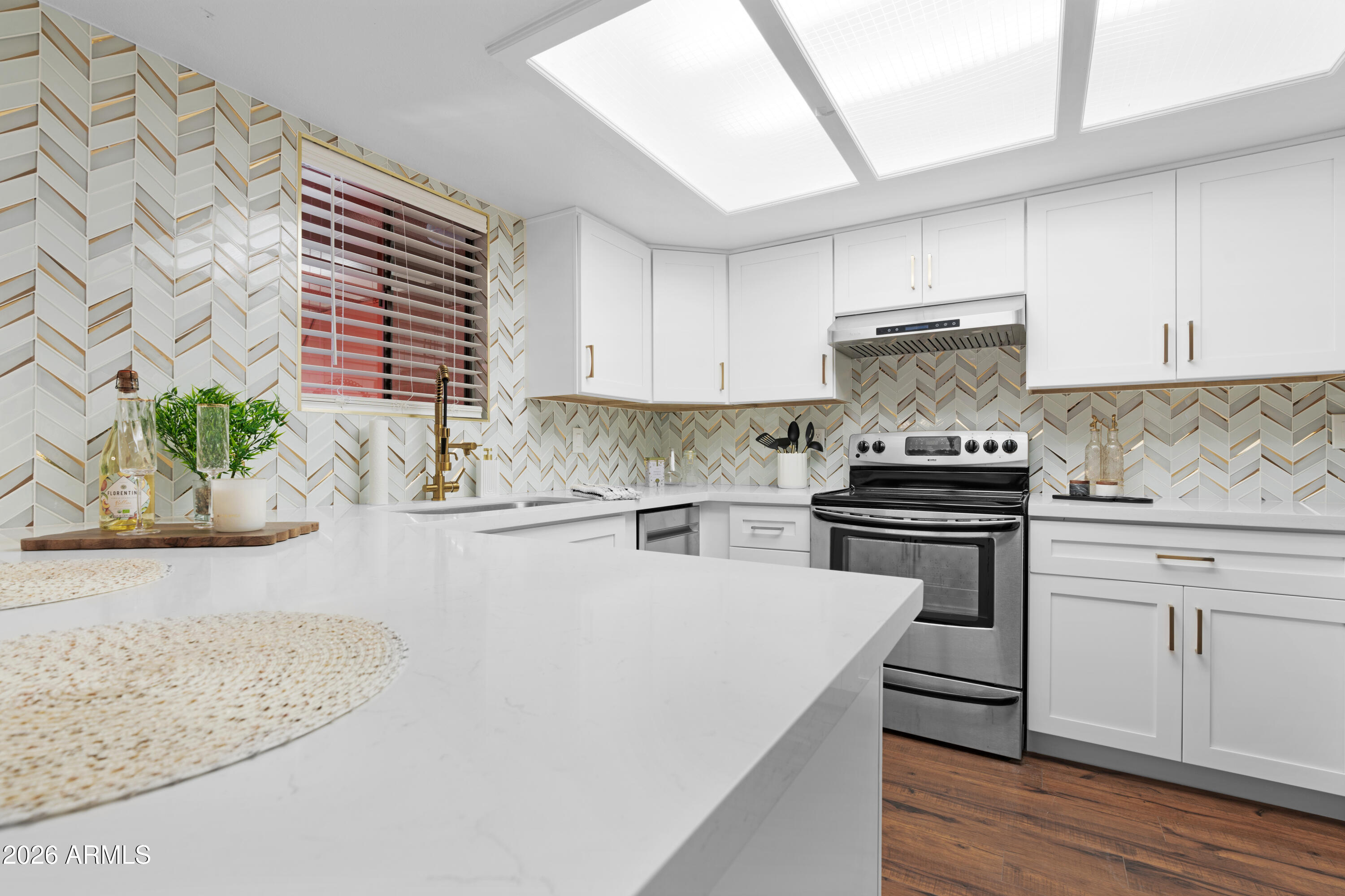 a kitchen with a stove a sink and a refrigerator