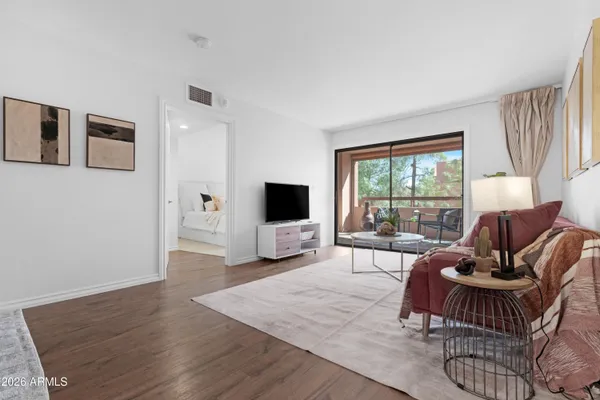 a living room with furniture and a wooden floor