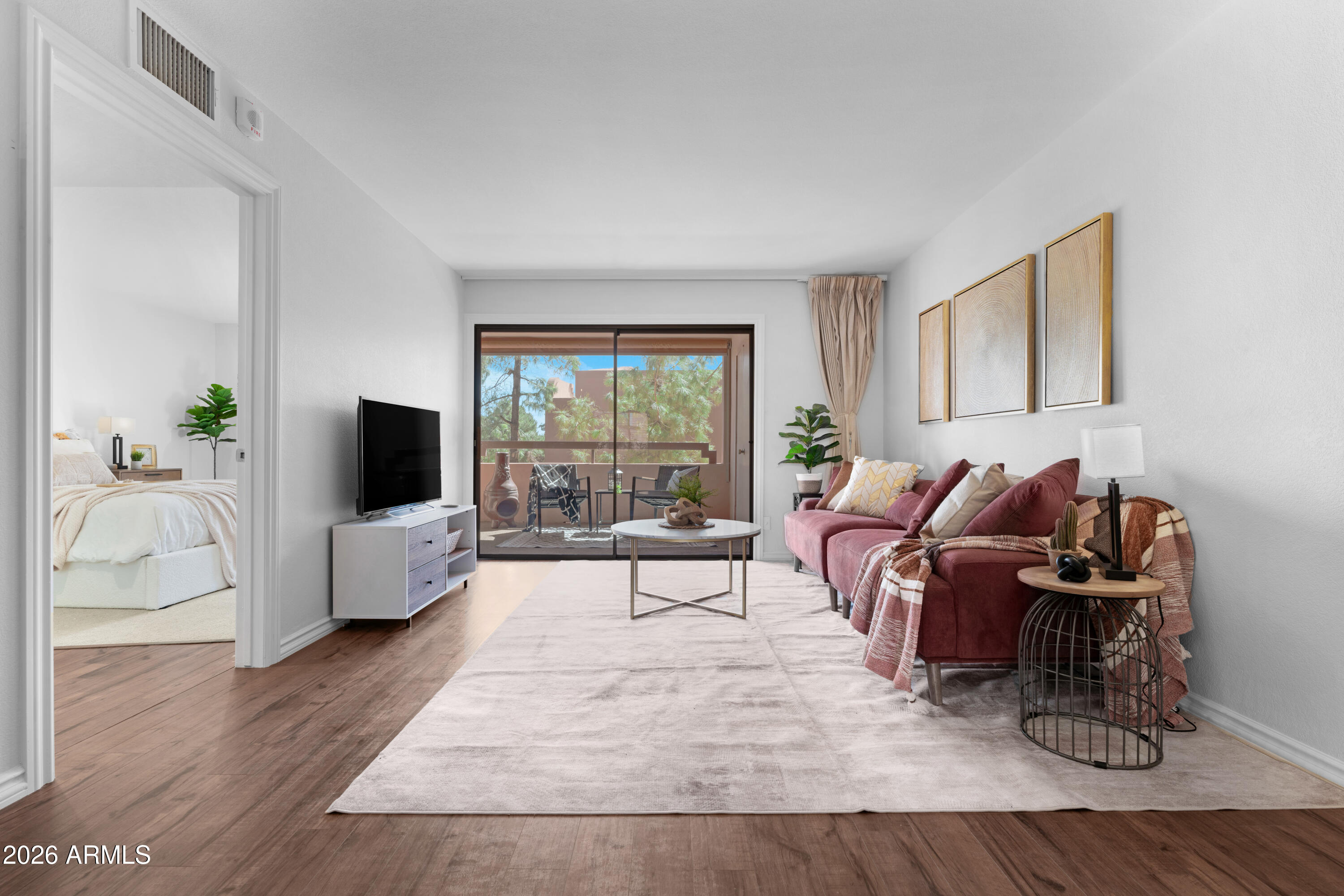 4303 East Cactus Road, Unit 410 Phoenix, AZ 85032 - Photo 14 of 50 a living room with furniture and a flat screen tv