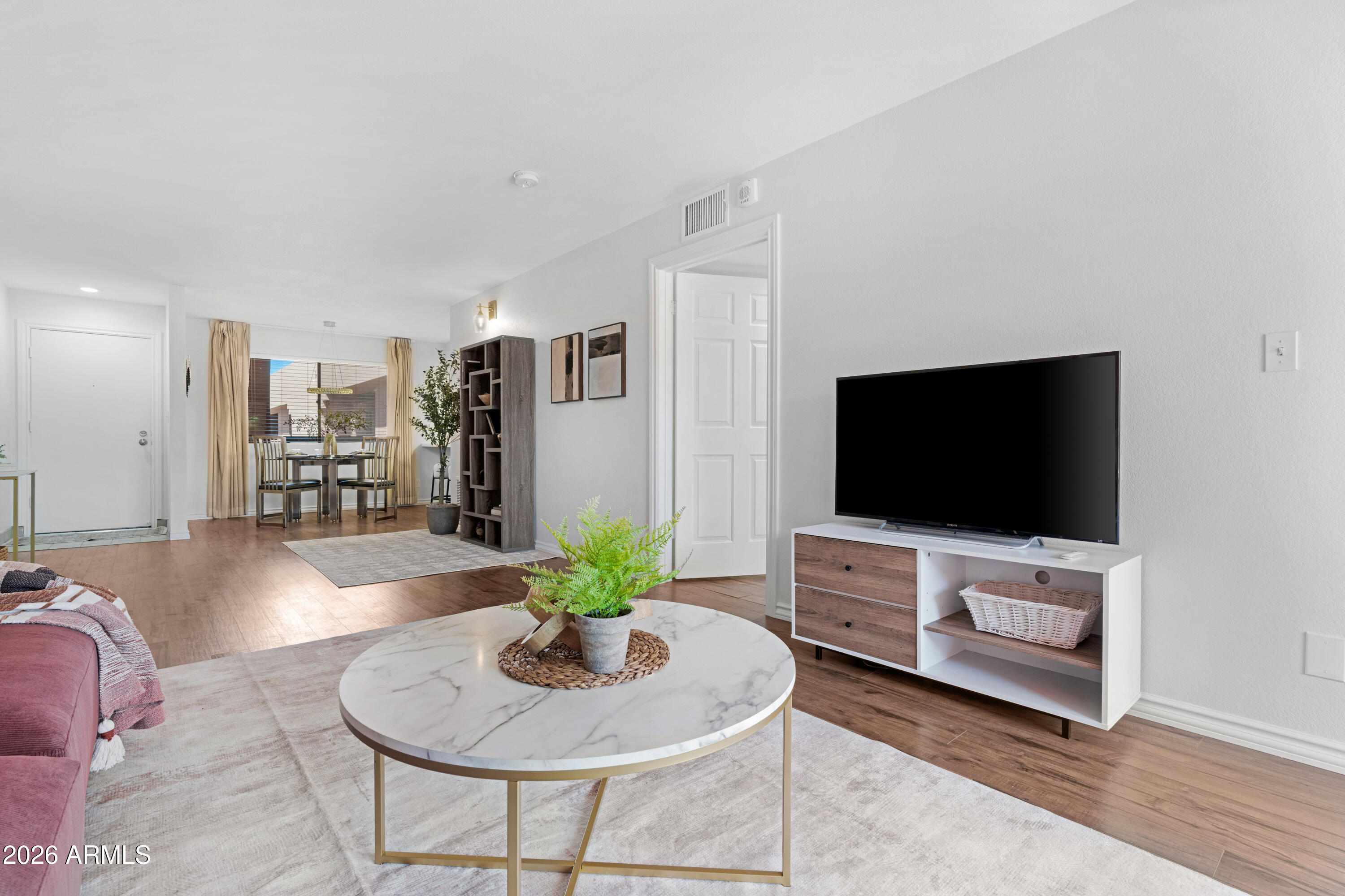 4303 East Cactus Road, Unit 410 Phoenix, AZ 85032 - Photo 16 of 50 a living room with furniture and a flat screen tv