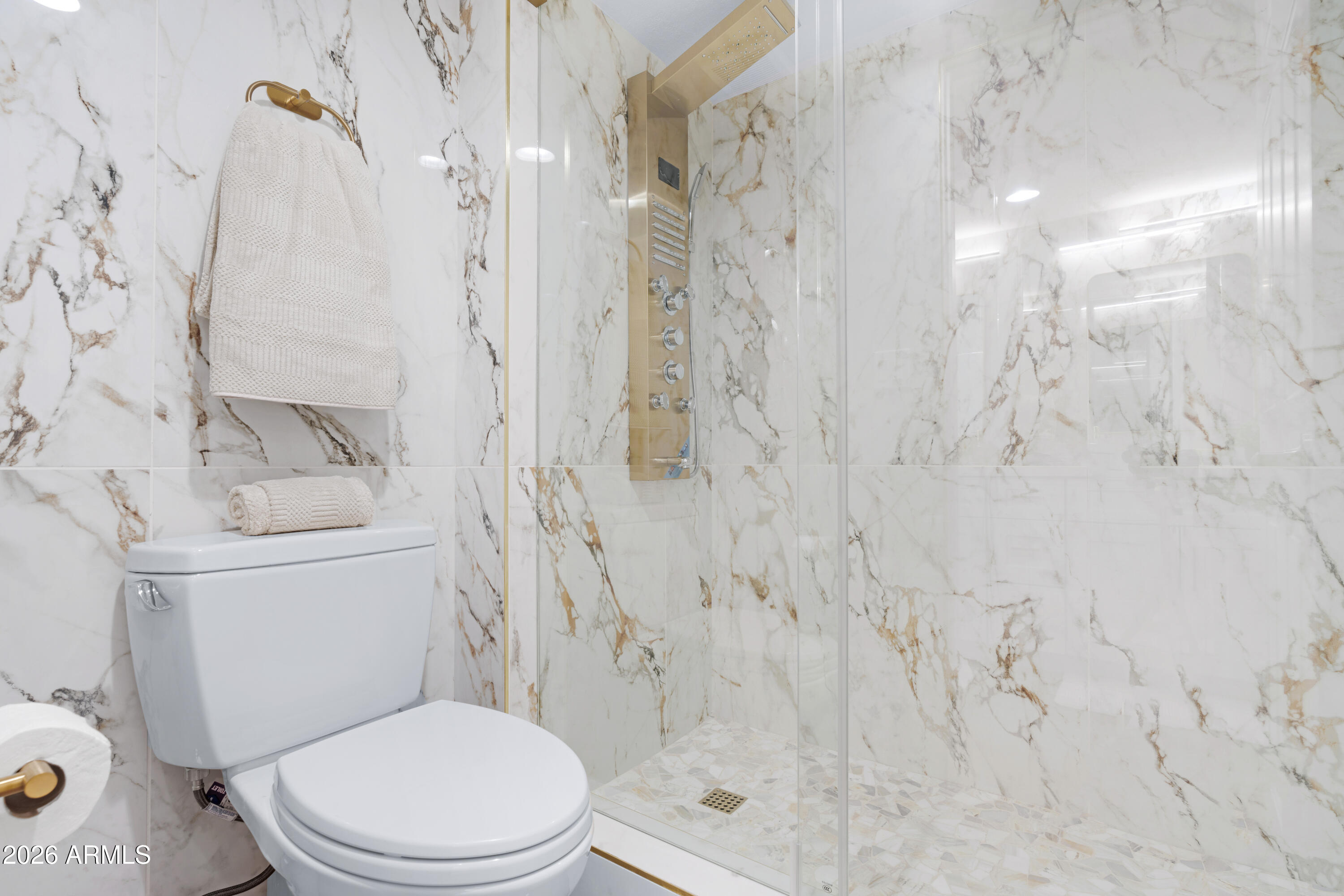 4303 East Cactus Road, Unit 410 Phoenix, AZ 85032 - Photo 24 of 50 a white toilet sitting next to a bath tub shower