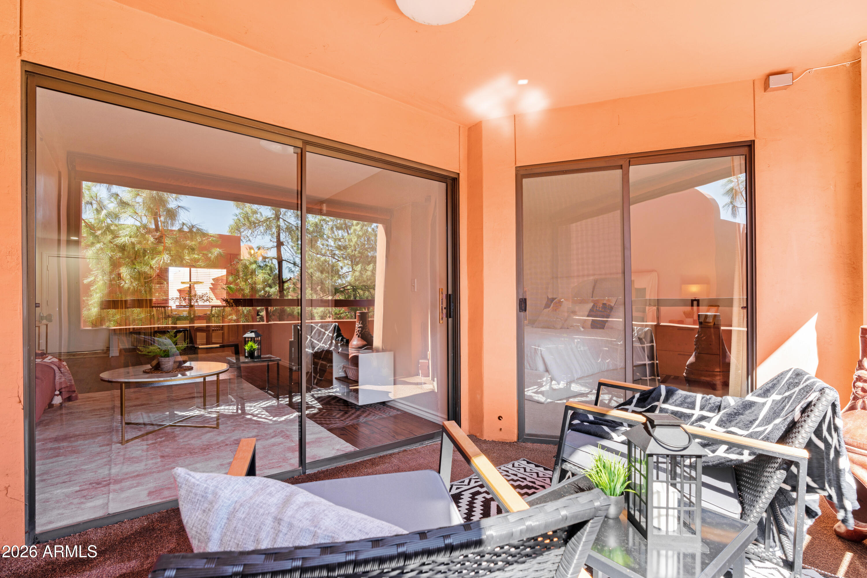 4303 East Cactus Road, Unit 410 Phoenix, AZ 85032 - Photo 32 of 50 a living room with couches a coffee table and a table with garden view