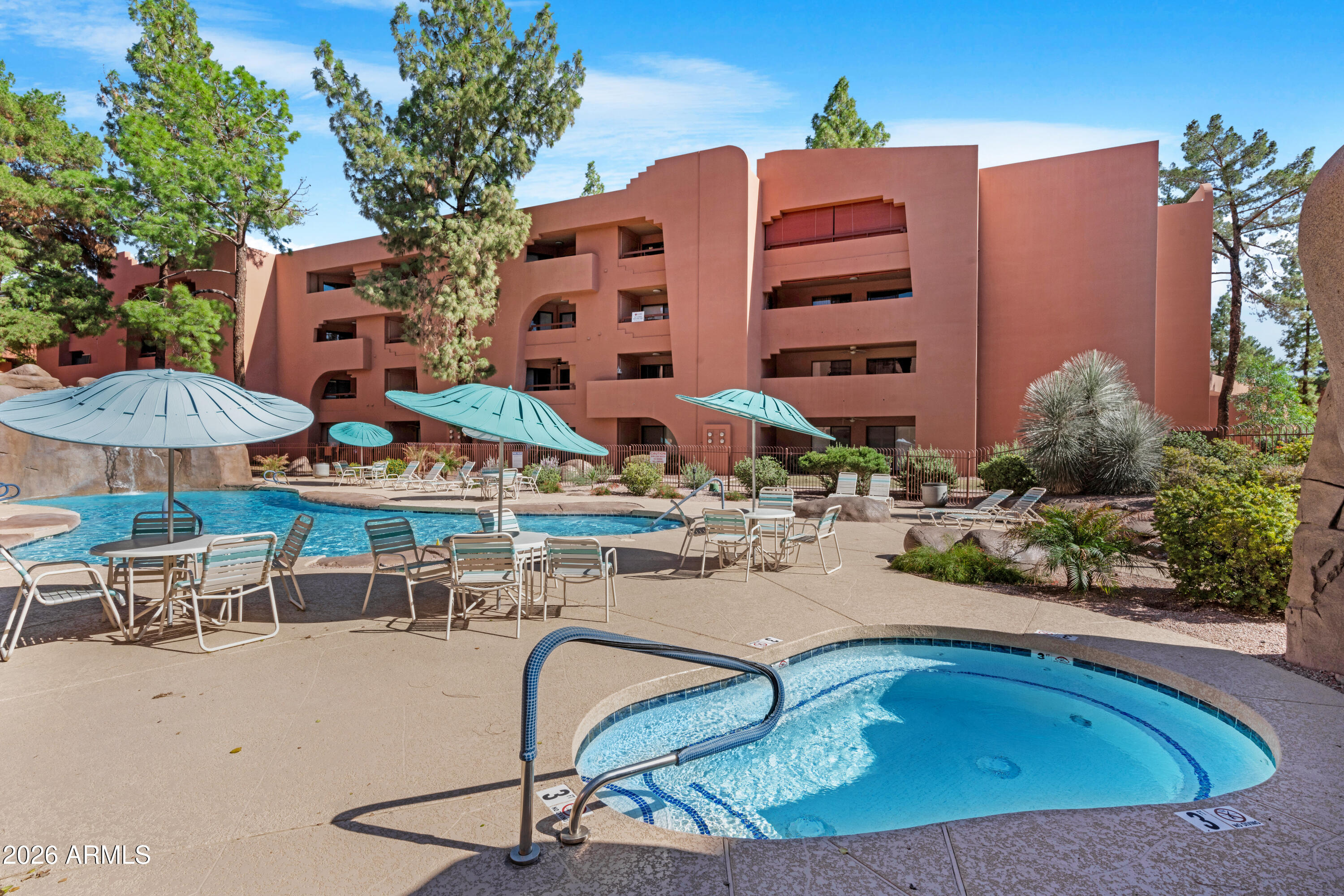 4303 East Cactus Road, Unit 410 Phoenix, AZ 85032 - Photo 5 of 50 a view of a patio with swimming pool table and chairs