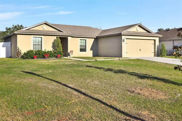 a front view of a house with a yard and garage