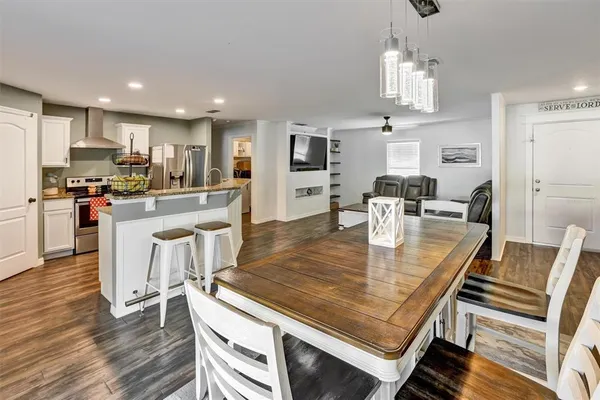 a large kitchen with a table and chairs