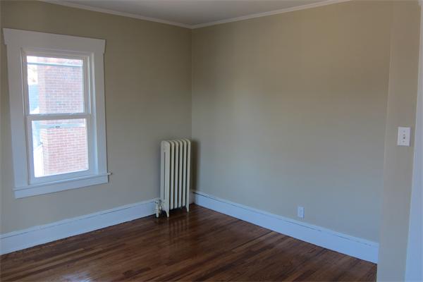 43 Appleton Street Springfield, MA 01108 - Photo 12 of 29 a view of an empty room with wooden floor and a window