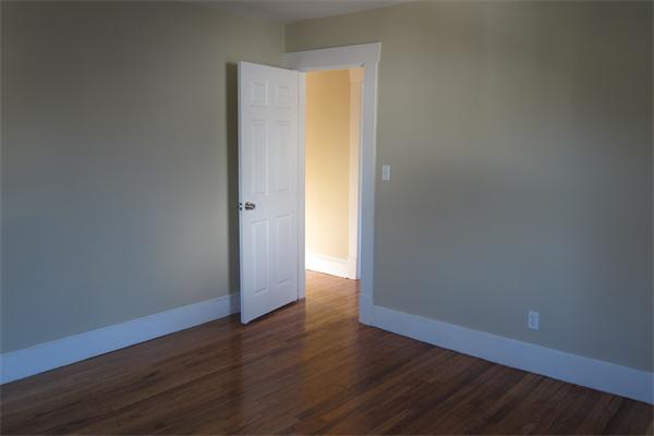 43 Appleton Street Springfield, MA 01108 - Photo 13 of 29 a view of an empty room with wooden floor and a window