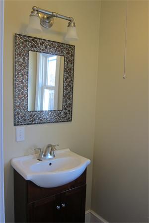 43 Appleton Street Springfield, MA 01108 - Photo 24 of 29 a bathroom with a sink a mirror and vanity