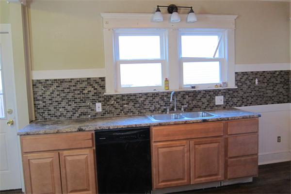 43 Appleton Street Springfield, MA 01108 - Photo 4 of 29 a kitchen with granite countertop a sink and cabinets
